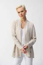Load image into Gallery viewer, Inject an air of casual elegance to any attire with this sleek Joseph Ribkoff cover-up. The gauze garment features a chic neckband and long sleeves that create a polished look. The insert band with decorative buttons adds a bit more flair to this lovely wardrobe essential. 