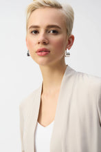 Load image into Gallery viewer, Inject an air of casual elegance to any attire with this sleek Joseph Ribkoff cover-up. The gauze garment features a chic neckband and long sleeves that create a polished look. The insert band with decorative buttons adds a bit more flair to this lovely wardrobe essential. 