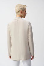 Load image into Gallery viewer, Inject an air of casual elegance to any attire with this sleek Joseph Ribkoff cover-up. The gauze garment features a chic neckband and long sleeves that create a polished look. The insert band with decorative buttons adds a bit more flair to this lovely wardrobe essential. 
