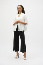 Load image into Gallery viewer, Infuse casual elegance into your everyday look with this beautiful Joseph Ribkoff cover-up. Crafted in textured jacquard fabric, the piece showcases three-quarter sleeves tailored with sleek slits, lending a refined appeal. The elongated hem at the sides elevates the garment’s straight silhouette while the side pockets add style and function to this classic wardrobe staple.