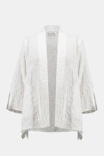 Load image into Gallery viewer, Infuse casual elegance into your everyday look with this beautiful Joseph Ribkoff cover-up. Crafted in textured jacquard fabric, the piece showcases three-quarter sleeves tailored with sleek slits, lending a refined appeal. The elongated hem at the sides elevates the garment’s straight silhouette while the side pockets add style and function to this classic wardrobe staple.