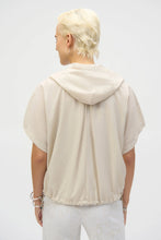 Load image into Gallery viewer, The definition of sporty chic, this Joseph Ribkoff hooded nylon jacket adds a trendy edge to your look. Featuring unexpected short dolman sleeves, front flap pockets, and a front zipper closure, it’s designed with a pleated back hem for added flair. An adjustable bungee cord lets you customize the relaxed fit to your liking.