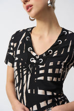 Load image into Gallery viewer, This shift dress gives off subtle island vibes with its tropical print and easygoing silhouette. Crafted from a lightweight silky knit that falls at the knees, it offers a flattering v-neckline with eyelet detailing, and short straight sleeves, making it a perfect summer-ready look.