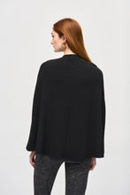 Load image into Gallery viewer, ​​Bring an air of casual elegance to your wardrobe with this chic cover-up. Tailored in a jacquard sweater knit fabric, the garment features a sleek crew neck with a military shank button detail, giving the piece an irresistible appeal. The poncho silhouette’s versatile style is the perfect canvas to create a look to suit any occasion.
