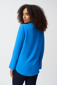 Indulge in the casual elegance of this lovely gauze top. The piece is tailored in a polished straight silhouette with a sleek shirt collar and front buttons, a classic, yet versatile look that can effortlessly transition from morning meetings to evening cocktails. The three-quarter sleeves with folded cuffs add character to this modern-style staple.