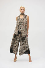 Load image into Gallery viewer, This chiffon tunic boasts a captivating animal print that exudes undeniable glamour. The piece features a sleeveless A-line silhouette and a chic scoop neckline, lending a sophisticated feel with timeless appeal. The garment’s reversible design and detachable scarf with fringe at the hem allow you to transform your look to suit any occasion. 
