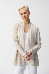 Inject an air of casual elegance to any attire with this sleek Joseph Ribkoff cover-up. The gauze garment features a chic neckband and long sleeves that create a polished look. The insert band with decorative buttons adds a bit more flair to this lovely wardrobe essential.&nbsp;