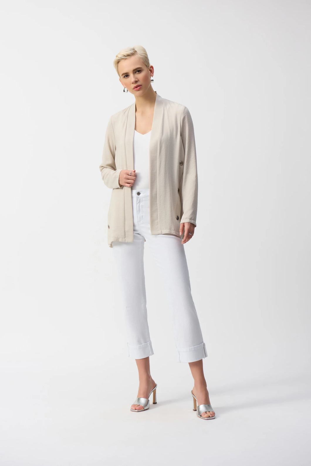 Inject an air of casual elegance to any attire with this sleek Joseph Ribkoff cover-up. The gauze garment features a chic neckband and long sleeves that create a polished look. The insert band with decorative buttons adds a bit more flair to this lovely wardrobe essential. 