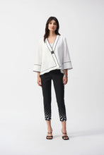Load image into Gallery viewer, This Joseph Ribkoff jacket highlights flawless style and undeniable poise. Crafted in a jacquard fabric, the garment presents a chic swing silhouette with a charming front button closure creating a beautiful V-shaped neckline when secured. The three-quarter cuffed sleeves lend a bold look to this remarkable contemporary piece.
