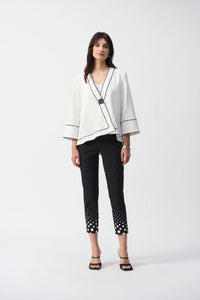 This Joseph Ribkoff jacket highlights flawless style and undeniable poise. Crafted in a jacquard fabric, the garment presents a chic swing silhouette with a charming front button closure creating a beautiful V-shaped neckline when secured. The three-quarter cuffed sleeves lend a bold look to this remarkable contemporary piece.