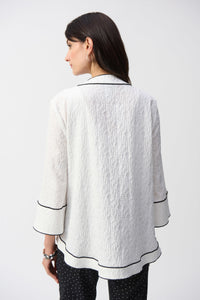 This Joseph Ribkoff jacket highlights flawless style and undeniable poise. Crafted in a jacquard fabric, the garment presents a chic swing silhouette with a charming front button closure creating a beautiful V-shaped neckline when secured. The three-quarter cuffed sleeves lend a bold look to this remarkable contemporary piece.