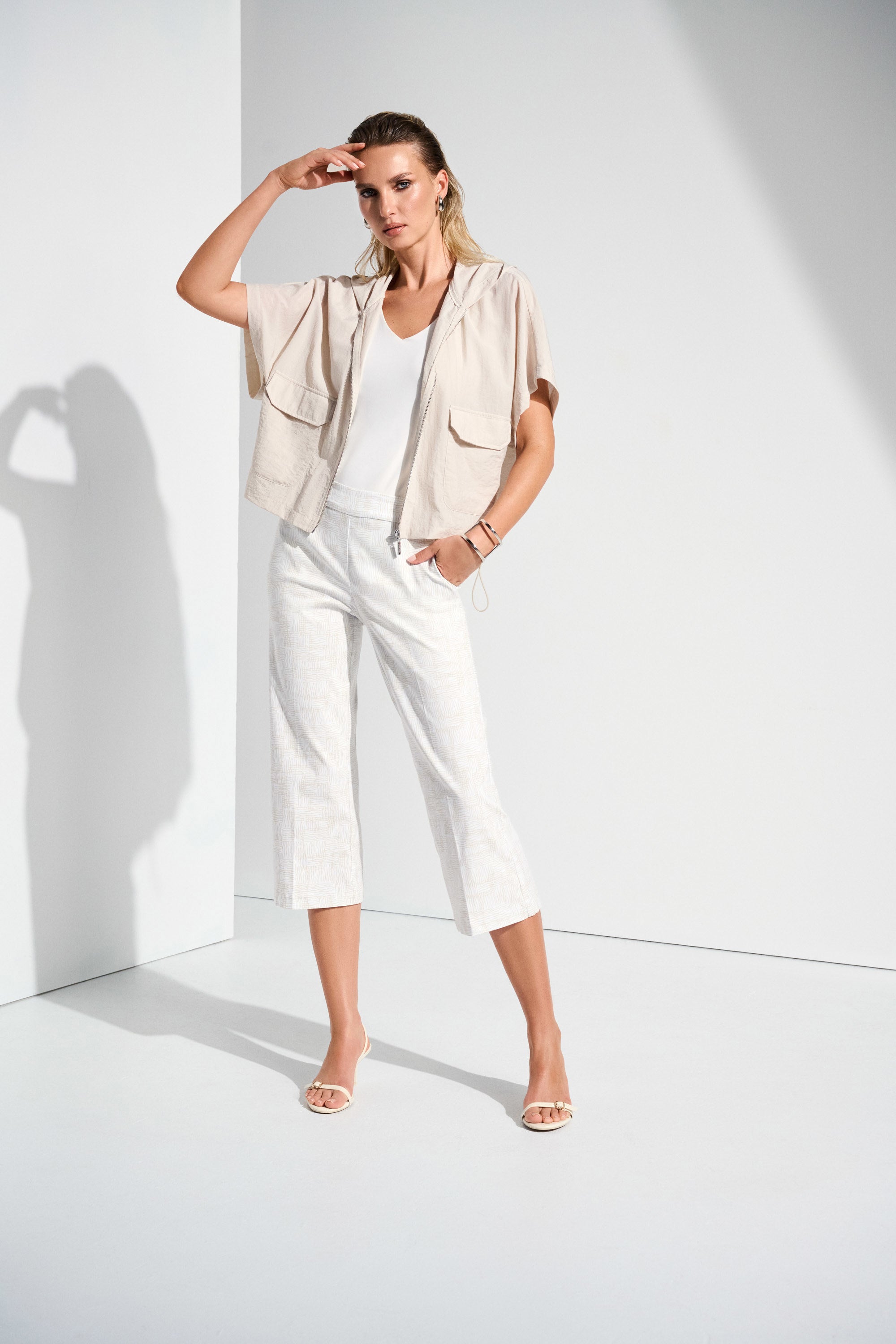 The definition of sporty chic, this Joseph Ribkoff hooded nylon jacket adds a trendy edge to your look. Featuring unexpected short dolman sleeves, front flap pockets, and a front zipper closure, it’s designed with a pleated back hem for added flair. An adjustable bungee cord lets you customize the relaxed fit to your liking.