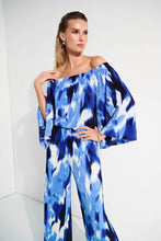 Load image into Gallery viewer, With its alluring off-shoulder neckline and striking tropical print, this Joseph Ribkoff flared top is pure vacation vibes; all that&#39;s missing is a mocktail. Three-quarter bell sleeves enhance its relaxed charm, while the pleated novelty fabric adds a subtle touch of texture.
