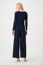 Load image into Gallery viewer, Silky Knit Wide Leg Wrap Jumpsuit

This wide-leg jumpsuit in silky knit features a wrap-style neckline and long straight sleeves for a refined silhouette. An overlapped leg on one side is accente…

