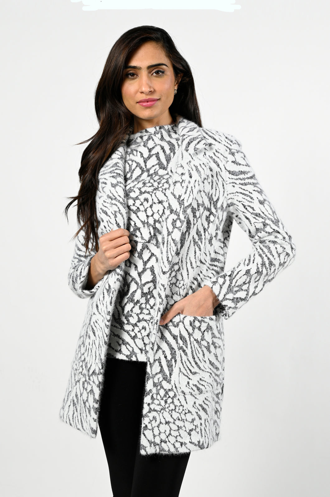 Off white and black, two piece fuzzy tunic sweater coat with pockets  85.5% Nylon  34.5% Polyester 